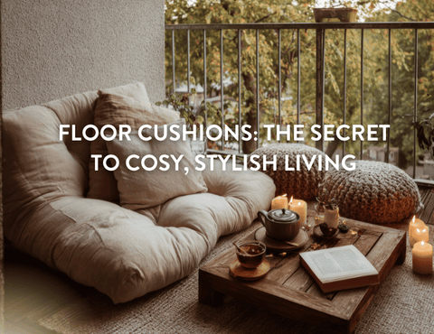 Floor cushions arranged around a table with a tea pot and candles on it